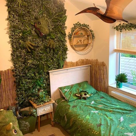 How awesome is this dinosaur bedroom Sarah McCabe created?! 😍 Faux living wall panels - IKEA Dinosaur head - Mask from Amazon, stuffed Hanging pterodactyl - kite from Jurassic Kites Reed fencing - Home Bargains #diy #onabudget #kidsroom #childsbedroom #themedecor #homedecor #dinosaur Ikea Dinosaur, Faux Living Wall, Dinosaur Theme Room, Reed Fencing, Dinosaur Room Decor, Dinosaur Bedroom, Dinosaur Head, Dinosaur Room, Head Mask