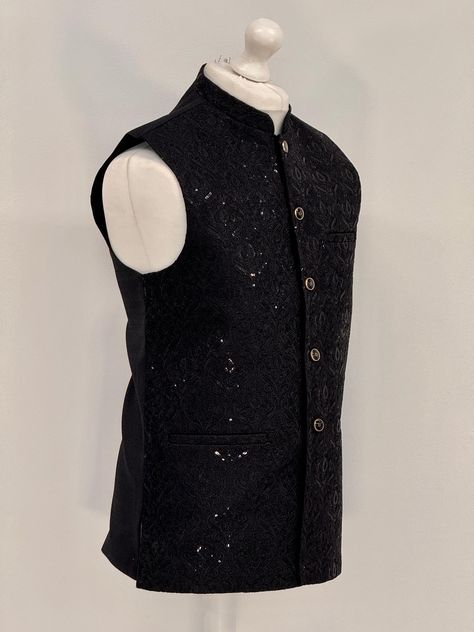 Introducing our exquisite Men's Jamawar Waistcoat, a luxurious addition to any gentleman's wardrobe. Handcrafted from the finest quality Jamawar fabric, this waistcoat is fully lined for added comfort. Featuring a timeless design, it comes with silver and black buttons that add a touch of elegance to any outfit. The waistcoat also comes with pockets, providing ample storage space for your essentials. Perfect for formal occasions, this waistcoat is sure to make a statement and impress all those a Black Gilet, Gentleman's Wardrobe, Waistcoat Men, Mens Clothing, Black Button, Black Sequins, Formal Occasion, Storage Space, Clothing Items