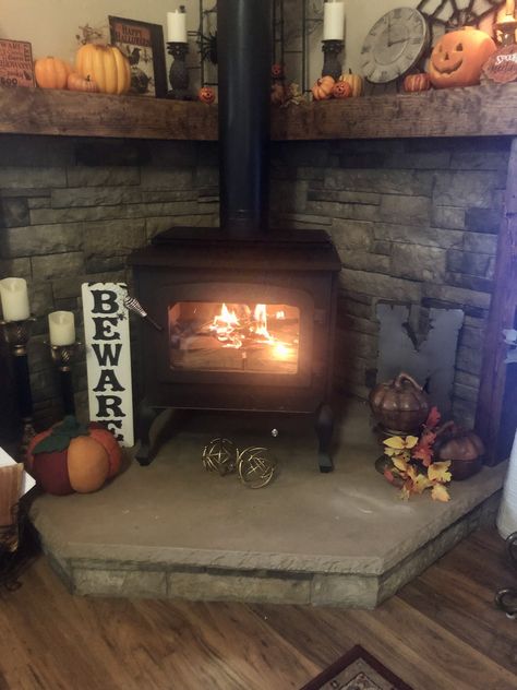 First fire in our wood stove. So happy to finally have it all finished. Wood Stove Surround Corner Mantle, Wood Stove Corner Hearth, Corner Wood Stove Ideas Rustic, Christmas Wood Stove, Corner Pellet Stove Mantle, Farmhouse Snug, Wood Stove Corner Ideas, Corner Wood Burning Stove, Wood Stove In Manufactured Home