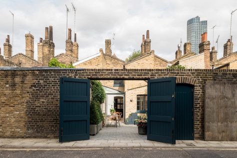 With the doors open, a car can pull in and park in the courtyard (you can roll aside the wooden planters, which are on wheels, before parking). Urban Gardening Ideas, Brick Siding, Mad About The House, Two Bedroom House, London House, Urban Gardening, Georgian Homes, Modern Door, Row House