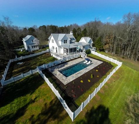 My favorite kinds of houses at the moment could probably be described as “Modern Farmhouse,” with white board and batten siding, tall windows, and big front porches. I had pinned this photo to my “Hou Farmhouse Pool, Pool Features, Dream Farmhouse, Dream Property, Mini Farm, White Farmhouse, Farmhouse Exterior, Carriage House, Farmhouse Plans