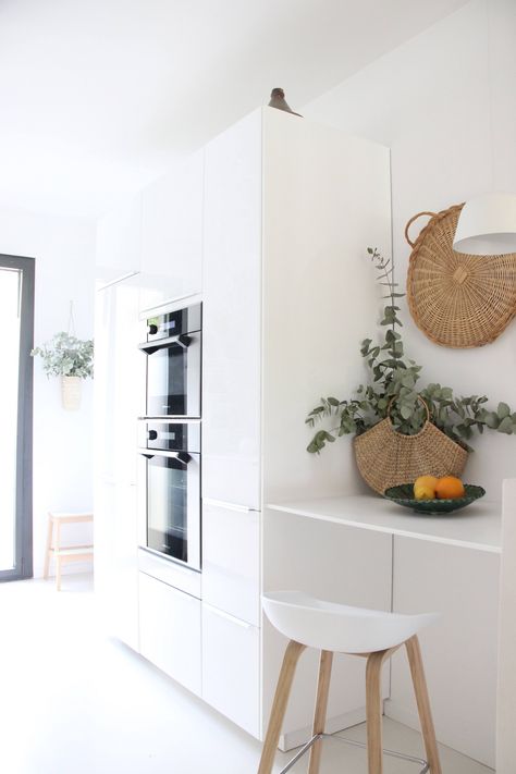 On the opposite side of the room, Ikea Ringhult cabinets in glossy white create a workhorse storage system. Ringhult Kitchen, Ikea Breakfast Nook, Ikea Ringhult, Old Kitchen Remodel, Colonial Kitchen Remodel, Tiny Kitchen Remodel, 1970s Kitchen Remodel, Inexpensive Kitchen Remodel, Condo Kitchen Remodel