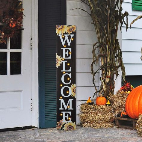 Features sentiment that reads Welcome, colorful finish and lovely sunflower motifs. Block combines a rustic backdrop with colorful embellishments and themed icons. Greet guests and passersby with a message of seasonal cheer with sunflower and WELCOME porch sign. The design can be enjoyed as is during the day, and then again at night when it's illuminated.1. 14 bulbs with warm white light2. 2 AA batteries are needed3. Decor makes a unique home decor item4. Porch sign will brighten any space in yo Harvest Porches, October Decor, Welcome Porch Sign, Themed Icons, Sunflower Home Decor, 3d Pumpkin, Porch Pumpkins, Rustic Backdrop, Wooden Porch