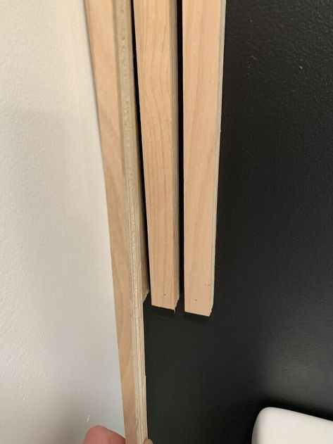 Use Plywood Strips to Create a Statement Wall | Hometalk Wood Slat Wall Behind Vanity, Toilet With Wood Wall, Wood Slats Behind Toilet, Toilet Wood Wall, Black Statement Wall, Diy Wood Slat Wall Rental, Candle Holder Makeover, Mitre Saw, Aging Terra Cotta Pots