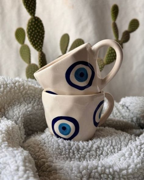 “✨ Sip in style and ward off negative vibes with our ceramic evil eye mug! Perfect for your morning coffee or evening tea. Grab yours today and protect your energy. 💙🧿 #EvilEyeMug #CeramicMagic #ShopNow” Mugs Painted, Evil Eye Mug, Ceramic Evil Eye, Pastel Home, Negative Vibes, Printed Mugs, Diy Pottery Painting, Protect Your Energy, Handmade Mugs