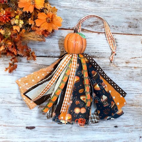 Listing is for one farmhouse style hanging tassel. Features ceramic topper with coordinating fabric and ribbon. Farmhouse Fall Crafts, Ornaments With Tassels, Fall Tassel Bag For Daily Use, Halloween Tassels, Beads With Tassels Decor, Scrap Fabric Tassels, Tassel Ornaments, Shaker Ornaments, Bible Tassel