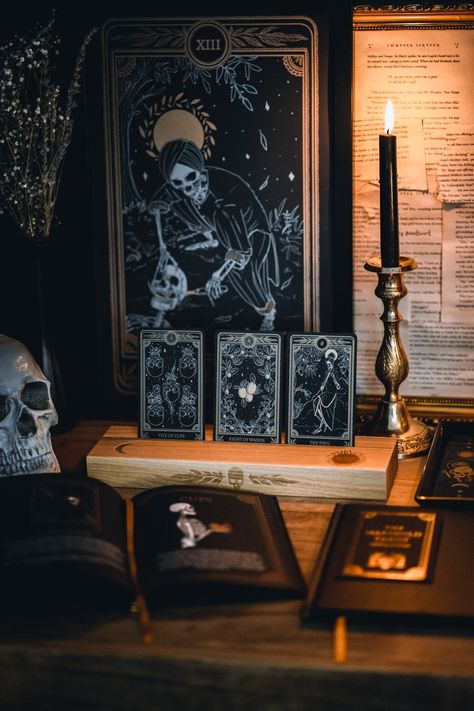 Ash wood card stand featuring a hot-stamp of a skull and marigold leaves, waning crescent moon, and the sun. Excellent for holding and displaying tarot readings while working, or for decorating your altar or desk. Comfortably fits three standard size 2.75” x 4.75” tarot or oracle cards. Stand colour may vary slightly due to differences in wood colouration. Care: Gently clean with lightly dampened cloth, allow to dry. Do not submerge in water. Dimensions: Approx 11.75" L x 3.5" W x 1.25" H / 30cm Astronomy Party, Marigold Leaves, Tarot Reading Room, Dark Astrology, Waning Crescent Moon, Halloween Tarot, Moon And The Sun, Waning Crescent, Hot Stamp