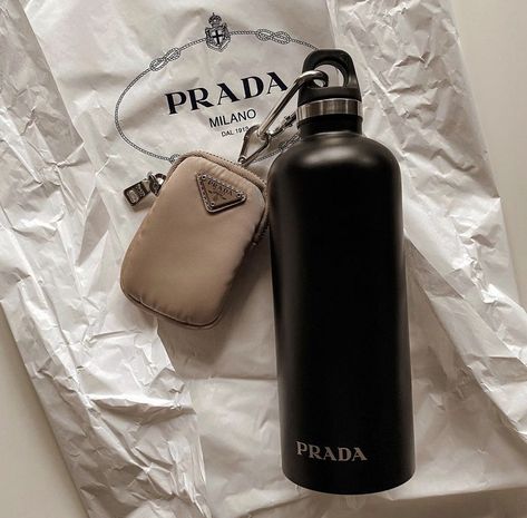 A Prada water bottle, coin bag, and paper bag. Prada Bottle Water, Old Money Water Bottle, Expensive Water Bottle, Prada Water Bottle, Luxury Water Bottle, Luxury Influencer, Instagram Pic Ideas, Aesthetic Money, Digital Content Creator