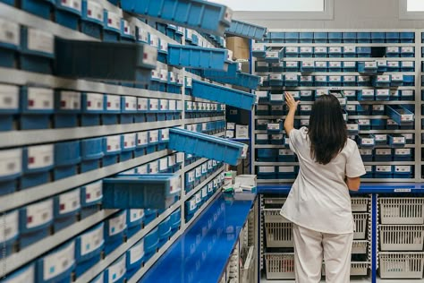 Pharmacist Working With Boxes | Stocksy United Pharmacy Photography, Pharmacist Aesthetic, Pharmacy Pictures, Hospital Pharmacist, Apothecary Branding, Pharmacy Aesthetic, Pharmacy School Study, Staff Photography, Global Health Issues