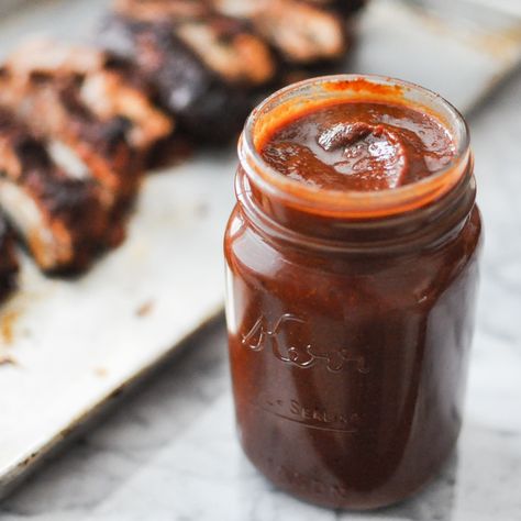 mason jar full of paleo barbecue sauce on a marble table with ribs blurred in the background Paleo Bbq Sauce, Homemade Barbecue Sauce Recipe, Paleo Bbq, Bbq Sauce Homemade Easy, Paleo Barbecue Sauce, Homemade Bbq Sauce Recipe, Paleo Sauces, Fed And Fit, Homemade Barbecue