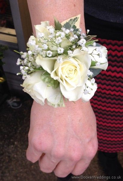 Don't spoil your wedding outfit with a pin - get one of these Ivory Rose and Gypsophila Wrist Corsages for the ladies in the bridal party | Bridal Florist (Booker Flowers and Gifts) Booker Weddings are Wedding Flower specialists and have been specially selected to be one of Interflora's Vera Wang Wedding Florists. Wedding Flowers White Roses, Prom Flowers Corsage, Prom Corsage And Boutonniere, Wedding Flowers Roses, Bridesmaid Corsage, Flowers And Gifts, Modern Wedding Flowers, Tropical Wedding Flowers, Corsage And Boutonniere