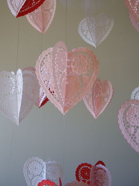 Do you remember McKenna’s mobile and the Fall leaf mobile/wind catcher I made last year? Well this is similar, except I’m using hearts and I’m calling it a chandelier. I found these cute paper doily hearts in the cake decorating area in Wal-Mart. Everything else I already had on hand. Ignore that pink ribbon, I … Leaf Mobile, Paper Doily Crafts, Doily Crafts, Saint Valentin Diy, Valentines Bricolage, Wind Catcher, Doilies Crafts, Diy Valentine's Day Decorations, Diy Valentines Decorations