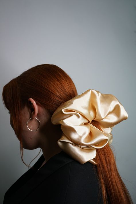 Girl with pony tail that has large beige scrunhie in hair - the girl is wearing black suit and she is siting by white background Gold Scrunchie, Giant Scrunchie, Never Grow Old, Scrunchie Hair, Your Hairstyle, Fall Accessories, Cute Packaging, Scrunchie Hairstyles, Growing Old