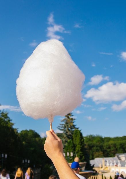 A man's hand holds cotton candy against ... | Premium Photo #Freepik #photo #cotton-candy #sugar-background #fair #sweet-background Cotton Candy Clouds, Male Hands, Cotton Wool, Premium Photo, Cotton Candy, Holding Hands, White Cotton, Blue Sky, Jam