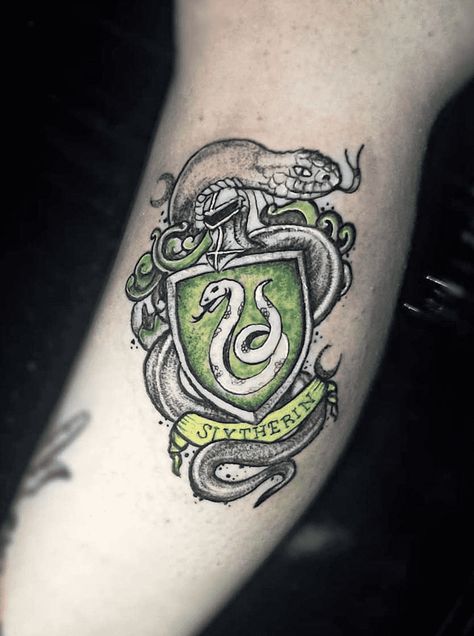 Slytherin Tattoo Design Images (Slytherin Ink Design Ideas) Slytherin Tattoo Ideas Hogwarts Houses, Slytherin Crest Tattoo, Hogwarts Legacy Tattoo, Harry Potter Slytherin Tattoo, Slytherin Tattoo Minimalist, Harry Potter Tattoos Slytherin, Slytherin Tattoo Ideas, Ravenclaw Tattoo, Slytherin Tattoo