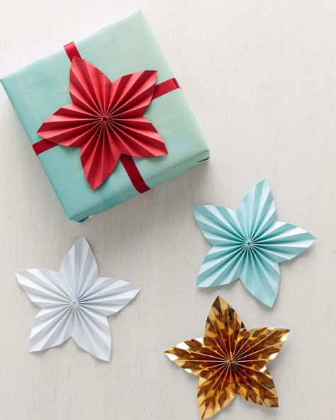 Instead of topping gifts with a bow, try this paper star craft from Martha Stewart. Shop for all of your holiday crafting supplies at Michaels. Gift Toppers Christmas, Christmas Crafts Diy Projects, Diy Star, Paper Bow, Unique Gift Wrapping, Seasonal Treats, Folded Paper, Stars Craft, Diy And Crafts Sewing