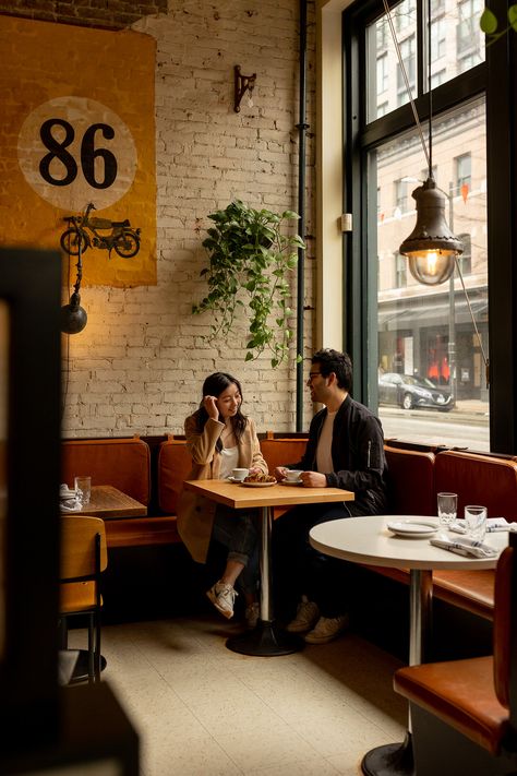 couple sitting in gastown coffee shop during engagement session Couple At Coffee Shop Aesthetic, Couple Poses Coffee Shop, Cafe Pose Ideas Couple, Engagement Pictures Coffee Shop, Coffeeshop Photoshoot Couple, Coffee Shop Proposal, Coffee House Engagement Photos, Coffee Shop Engagement Shoot Photo Ideas, Bakery Engagement Photos