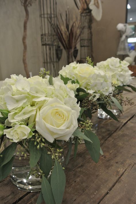 Small centerpieces with hydrangea, rose, spray roses, seeded eucalyptus Hydrangea And Spray Rose Centerpiece, Small White Rose Centerpiece, White Roses Eucalyptus Centerpiece, Small White Floral Centerpieces, Small Hydrangea Centerpiece, Roses And Eucalyptus Centerpiece, Roses And Hydrangea Centerpieces, Seeded Eucalyptus Centerpiece, Ranunculus Centerpiece