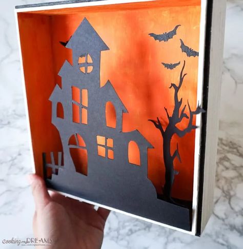 This is what your Halloween decor was missing! A cute wooden Halloween shadow box with a haunted house, a spooky tree and eerie lights. It's really easy to make, also together with your kids! Check the step-by-step instructions, hyper-lapse video and download the printable template for the silhouettes to have your new Halloween decoration in no time! #easycraft #halloweendecoration #diyhomedecor #spookydecor Hyperlapse Video, Alice Halloween, Halloween Shadow, Do It Yourself Decoration, Halloween Shadow Box, Bricolage Halloween, Spooky Tree, Halloween Creative, Casa Halloween