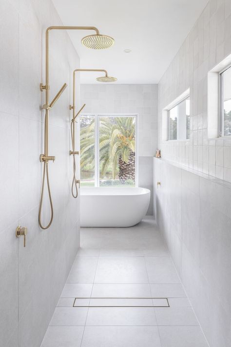 A luxurious bathroom features a walk in shower and freestanding bath with brushed brass tapware. Lakehouse Bathroom, Brushed Brass Tapware, Brass Tapware, Abi Interiors, Post And Beam Home, Bathroom Shelving, Small Bathroom Renovations, Double Shower, Bath Mirror