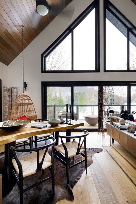 Dining Room, Table, Medium Hardwood Floor, Chair, and Pendant Lighting Black-framed, custom windows by Euro Vinyl are chic frames to the outdoors. Frames Ideas, Black Window Frames, House Design Trends, Black Window, Primitive Homes, Exterior Wall Design, Rustic Home Design, Black Windows, Open Living Room