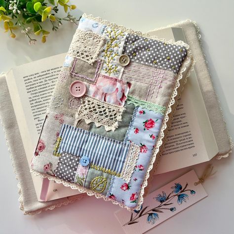 Keep you book protected in a beautiful way. Perfect choice for those who love handmade and unique covers for their books, notebooks, journals...This book cover is made of different fabrics in patchwork style, with handmade embroidery, stitches, cotton lace trim and few buttons. It is lined with wadding and lining and has a pink satin ribbon as a bookmark. You can chose between two styles. Size when is open - 34 x 22 cm / 13.4 x 8.7 inches approx. A perfect gift for your loved ones! Care - hand washing. Мake your life happier ❤️ Thank you for visiting my shop! Manufacturer: Sonya Iv Design Ltd Bulgaria, Sofia, Ilinden, bl.150, ap. 47 e-mail: ivanovastudio@abv.bg Bulgaria Sofia, Handcrafted Journals, Sewing Case, Book Protector, Diary Covers, Handmade Embroidery, Journal Covers, Book Accessories, Pink Satin