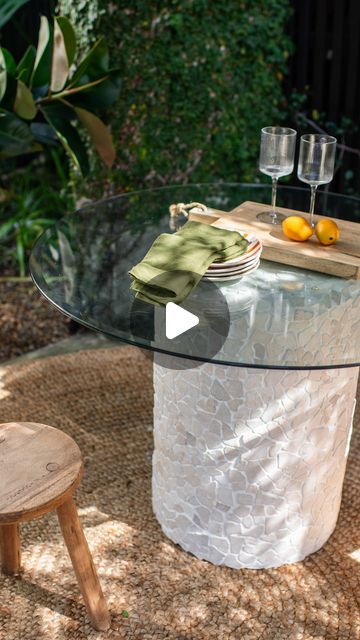 Geneva Vanderzeil on Instagram: "Making a stone pedestal outdoor table! Welcome to my new series of Aisle Upcyles, where I find discarded and secondhand items and give them a whole new life using things from the aisles of @Bunnings! My first project? To upcycle a round glass table top that I found without a base on the road during kerbside collection. Challenge accepted! Armed with a large outdoor pot, some mosaic tiles, grout and sticky glass tabletop bumpers from @bunnings, I decided to turn the pot upside down and tile the outside to create a cute stone outdoor table! I’d love to hear what you think of this one. #bunnings #bunningsinspo #diy #upcycling #upcycle" Diy Glass Top Table, Diy Table Base For Glass Top, Diy Coffee Table Base For Glass Top, Diy Round Table Base, Tile Round Table Top Diy, Tiled Table Top Outdoor, Diy Glass Table, Stone Outdoor Table, Mosaic Patio Table Diy