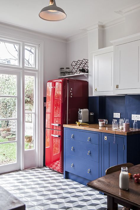 We love the kitchen's red Smeg fridge and overall homemade look.  #Kitchen #Colorful #ColorfulKitchen #BlueCabinets #BlueKitchen #BluePaint #PaintedCabinets #KitchenCabinets #KitchenRemodel #KitchenRemodeling #Remodeled #KitchenRemodeled #KitchenTiles #RedFridge #KitchenFridge #Fridge #Refrigerator #RedRefrigerator #Appliances #KitchenAppliances #Retro #RetroFridge #RetroDesign #RetroKitchen #RetroInteriorDesign Red Fridge Kitchen, British Standard Kitchen, Chestnut Kitchen, Red Fridge, Red Refrigerator, Smeg Refrigerator, London Homes, Smeg Kitchen, Full Kitchen Remodel