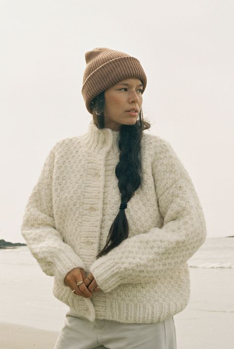 The OZMA Sweater Collection is made in Peru with the finest alpaca and wool yarns. All factories and yarn manufacturers are proudly Promperu Fair Trade Certified. The ideal slightly oversized, chunky knit cardigan — perfect for layering up when it's cold or worn alone with a favorite pair of jeans. Hand knit in the softest Caraveli yarn, with buttons up the front and a slight bell sleeve. The nature of the hand knit yarn will grow a bit with wear, so size down for your perfect fit that will last Oversized Cream Cardigan Outfit, Hand Knitted Cardigan, Copenhagen Style Winter Outfits, Chunky Cardigan Crochet, Chunky Cardigan Outfit, Cream Cardigan Outfit, Knit Kimono, Hand Knit Cardigan, Autumn Sweater