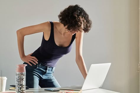 Attractive Business Woman Leaning On Table And Using Laptop | Stocksy United Someone Leaning Over A Table Reference, Hands On Table Pose, Feet Kicked Up On Desk Pose, Leaning Over Table Pose Reference, Lean On Table Pose, Leaning On Desk Pose Drawing, Leaning On Desk Pose Reference, Hands On Desk Pose, Leaning Over Desk Pose Reference