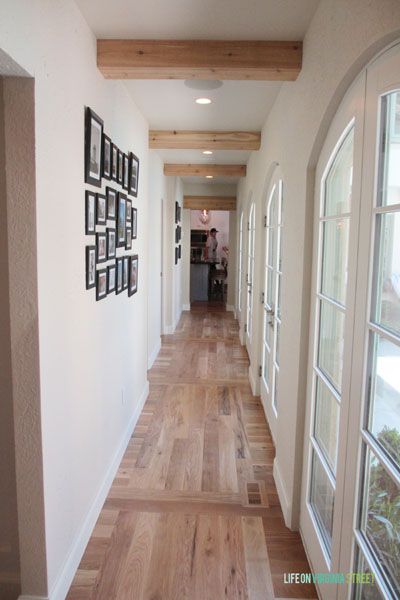 Gorgeous hallway with wood floors, french doors and exposed wood beams. Exposed Wood Beams, Wood Floor Pattern, Hallway Ceiling, Hotel Design Architecture, Wooden Beams Ceiling, Life On Virginia Street, Faux Wood Beams, Faux Beams, Wood Beam