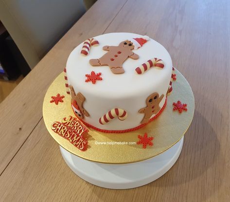 A gingerbread and candy cane theme christmas cake. Gingerbread Christmas Cake Decoration, Marzipan Cake Decoration Ideas, Candy Cane Christmas Cake, Christmas Cake Square, Gingerbread Man Birthday Cake, Gingerbread Theme Cake, Fondant Christmas Cake Ideas, Christmas Cake Fondant Decorating Ideas, Gingerbread Christmas Cake