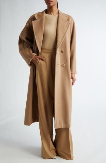 Expertly hand-stitched in the softest virgin-wool-and-cashmere blend, this long coat is a classic with a straight silhouette cinched by a waist-defining belt. 48" length (size 8) Double-breasted button closure Notched lapels Front welt pockets Removable tie belt Lined 90% virgin wool, 10% cashmere Dry clean Made in Italy Designer Clothing Quiet Luxury Fashion Fall 2024, Max Mara Coat Street Style, Tan Long Coat, Ceo Fashion, Elegant Capsule Wardrobe, Camel Winter Coat, Maxmara Coat, October Style, Camel Outfit