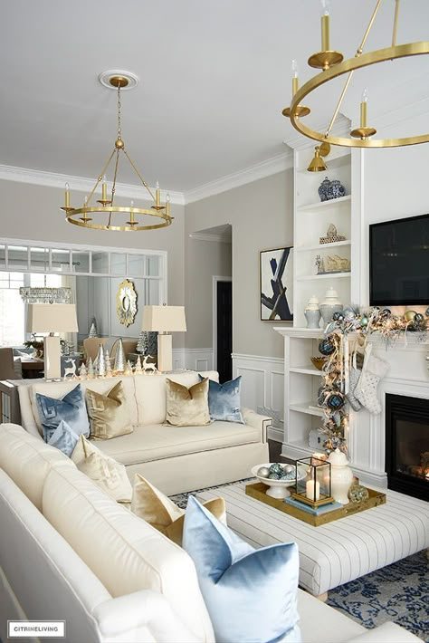 ELEGANT CHRISTMAS LIVING ROOM: SOFT BLUE, GOLD, SILVER + WHITE | CITRINELIVING | Bloglovin’ Two Light Fixtures In Living Room, Glam Lounge Room, White Blue And Gold Living Room, White Gold Decor Living Room, Blue Gold Decor Living Room, Blue Gray White Gold Living Room, Living Room With Gold Decor, Blue Gold Home Decor, Light Blue Lounge Room Decor