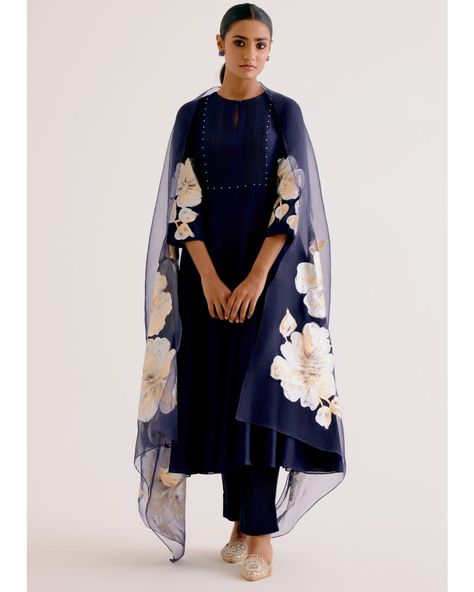 This navy blue anarkali set is a stunning blend of cotton and silk, adorned with intricate thread embroidery and hand-painted details. The kalidar kurta pairs beautifully with slim pants, and is completed with a delicately embroidered organza dupatta. Elevate your style with this elegant and unique ensemble. Clothing Business Ideas, Navy Blue Anarkali, Embroidery Hacks, Painted Dupatta, White Anarkali, Indian Closet, Blue Anarkali, Painting On Clothes, Fabric Painting On Clothes