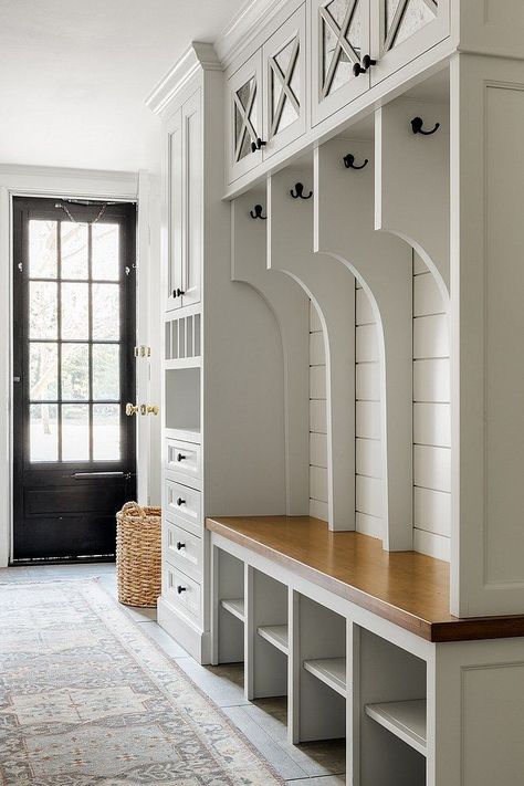 If you have a busy household, a mudroom can do wonders for your space. These small yet highly functional areas can give you extra storage and a place where everyone can hang their coats and umbrellas or store their muddy shoes. While traditionally a 'mudroom' may be to take off your muddy shoes, they're also a great place to hang wet towels at a beach house, put up your skis at a mountain home, or drop your bags and shoes in a city home. Really, the mudroom is a hub where you can stop and '... Mudroom With Catch All, Mudroom Storage With Bench, Interior Design Mudroom, Built In Benches, Mudroom Renovation, Built In Cubbies, Vstupná Hala, Mudroom Cabinets, Mudroom Lockers