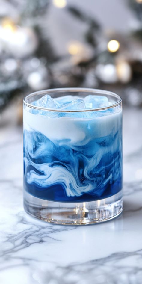 Russian Blue Moon Recipe Easy Sweet Drinks Alcohol, Smooth Alcoholic Drinks, Color Changing Drinks Alcohol, Sweet Mixed Drinks Alcohol Recipes, January Alcoholic Drinks, Dark Blue Cocktails, Blue Tequila Cocktails, Blue Winter Cocktails, Mixed Drinks Ideas