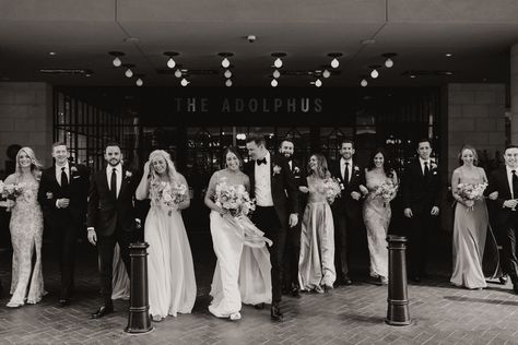 Black and white photo of the bride and groom, and bridal party walking in front of the Adolphus Hotel in Dallas, TX Bridal Party Hotel Pictures, The Adolphus Dallas Wedding, Adolphus Hotel Dallas Weddings, Hotel Wedding Photography, Bridal Party Wedding Photos, Party Wedding Photos, Hotel Pics, Bridal Party Photography, Old Hollywood Wedding