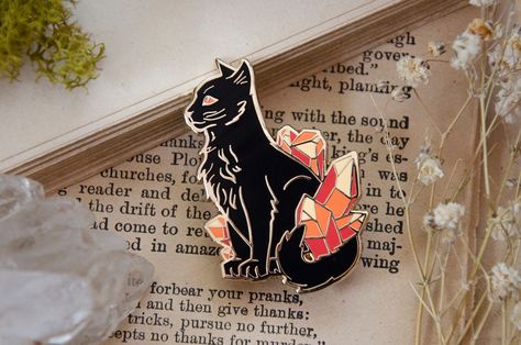 The carnelian cat represents - Elegance, confidence, and vitality. This is a 1.75" hard enamel pin, with gold plating and two gold butterfly clutches, packaged on a 2.5 x 3 inch backing card. Warrior Cats Enamel Pins, Enamel Pins Aesthetic, Patches And Pins, 75 Hard, Crystal Cat, Enamel Pin Collection, Pokemon Pins, Cat Enamel Pin, Carnelian Crystal