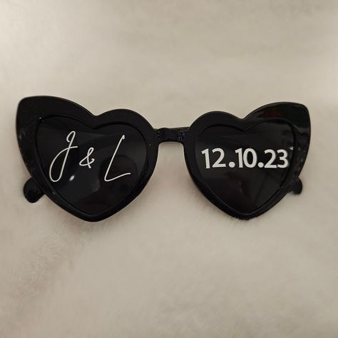 Heart-shaped black sunglasses with the perfect personalisation for your wedding, birthday, bachelorette or just for fun.  Frame:  - Acrylic Measurements: Bridge: 2.2cms Lens Height: 4.5cms Lens Width: 5.5cms (widest part) Temple Length: 14cms Vinyl Colour: - Matte White Font: Name/Initials - Mustard - Master - Brit - Snow - Strong Font: Date - Standard Plain font Personalisation Options (Facing Sunglasses) - Plain (No Personalisation) - Two Names (Left lens) + Date (Right lens) - Two Initials (Left lens) + Date (Right lens) - Two Names ( 1 Name on each lens) - Custom Processing Times - 5 - 7 Business Days. - 1 - 3 Business Days - (PLAIN SUNGLASSES ONLY) Delivery / Postage: - Tracked Postage - Express Postage Upgrade - We use Australia Post. Once the packages are with AP the delivery times Strong Font, Wedding Sunglasses, Heart Sunglasses, Wedding Bridal Party, Black Sunglasses, Black Heart, Hen Party, Vinyl Colors, Wedding Bridal