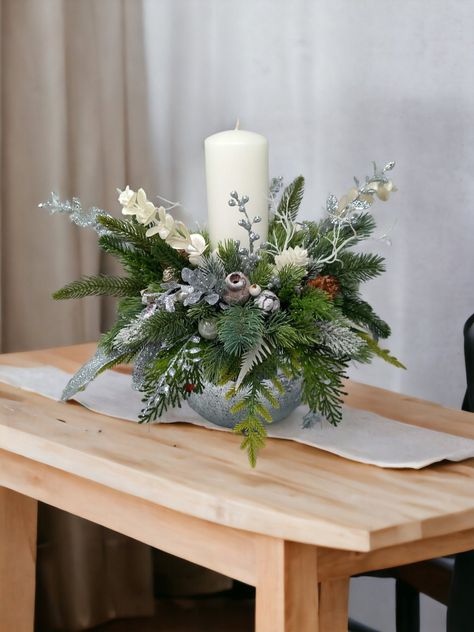 Welcome the most awaited season with this bright and gorgeous Christmas table centrepiece, Christmas table decorations, Christmas table display, Christmas candle display, Festive home decor, Holiday home decor. White and silver centrepiece made up of silver and white  Christmas berries picks adorned and a lot of 3D pine branch of different shade of green and one white tall ( 20cm/7,87 inch tall, 7 cm/ 2.75 inch width)  pillar candles. This arrangement are beautiful and very sparky what you can n Modern Christmas Arrangements, Silver And White Christmas Table Decor, Christmas Decor For Dining Room Table, Centre Table Noel, Silver Christmas Table Decorations, Entrance Table Christmas Decor, Side Table Christmas Decor, White And Silver Christmas Decor, White Christmas Table Decor