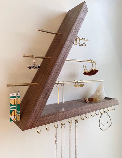 This wall mounted floating jewelry organizer is made with solid walnut, brass rods and brass hooks. This is a modern piece with an open triangle concept. It is dowel joined with no nails or screws, keeping the aesthetics of this piece, our number one priority. 100% solid walnut hardwood.  There are absolutely no stains applied to our wood.  We let the natural brilliance radiate with Sam Maloof poly/oil wood finish.   This organizer is a great platform to showcase your favorite jewelry pieces as Wall Mount Jewelry Organizer, Jewelry Organizer Wall, Diy Jewelry Holder, Jewelry Wall, Jewelry Organizer Diy, Wall Organization, Projects Ideas, Diy Organization, Big Time