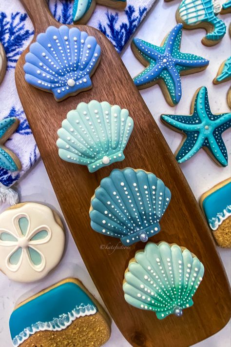 Ocean theme sugar cookies are trending now for baby showers Sea Life Cookies Decorated, Ocean Animal Cookies, Beach Wedding Cookies Decorated, Beach Theme Sugar Cookies, Under The Sea Cookies Decorated, Ocean Treats, Pool Cookies, Ariel Cookies, Beach Sugar Cookies