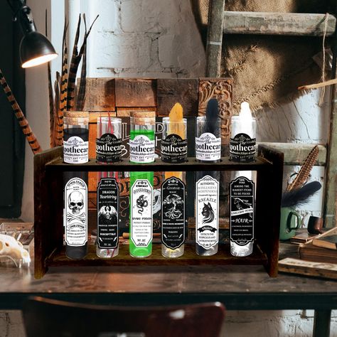 PRICES MAY VARY. Halloween Apothecary Potion Set: includes 6 test tube potion vials with corks, 1 apothecary rack, 6 black & white witch's labels, 2 colors and 4 different colors of feathers, adding to the mysterious atmosphere of the witch's apothecary bottles. The combination of magic potion test tubes and apothecary shelf is perfect for halloween decorations. Witch Theme Design: The sticker labels on these witches potion bottles are related to classic Halloween horror elements such as black c Gothic Halloween Party Decor, Witch Theme Decorations, Halloween Apothecary Display, Witch's Apothecary, Potion Bottles Halloween, Apothecary Shelf, Witchy Halloween Decor, Witchy Shop, Horror Elements