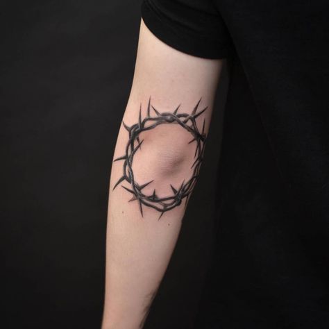 Black and grey crown of thorns tattoo located on the Crown Of Thorns Tattoo Around Elbow, Cross With Crown Of Thorns Tattoos For Men, Thorns Elbow Tattoo, Elbow Thorn Tattoo, Crown Of Thorns Elbow Tattoo, Crown Of Thorns Knee Tattoo, Crown Thorns Tattoo, Thorn Tattoo Men, Crown Of Thrones Tattoo