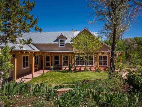 A touch of magic embraces this Northern New Mexico style home with studio which is nestled in a pastoral setting located in the village of Chupadero (north of Tesuque). The home is on a high plateau of the land with outstanding Sangre mountain and big sky views and the land slopes gently to the Rio Chupadero . Lush and green pasture like land with .89 acre feet of irrigation rights for the gardens and fruit trees. Potential for larger gardens and green dreams. If you want water, this is a mecc New Mexico Style Home, Santa Fe Style Homes, New Mexico Style, Santa Fe Home, Northern New Mexico, New Mexico Homes, Courtyard House Plans, Mexico Style, Santa Fe Style