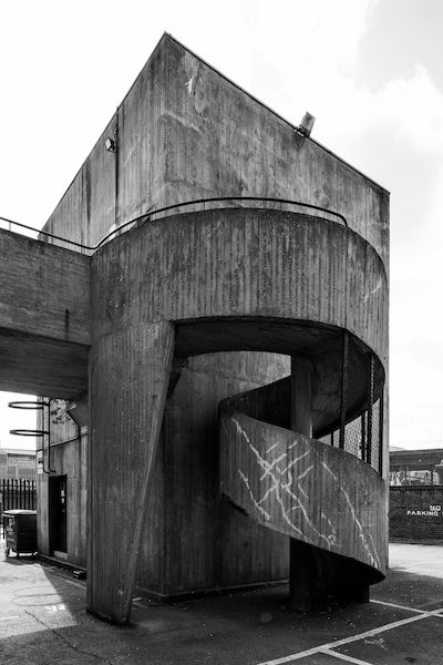 Eros House was designed by Rodney Gordon whose work includes two brutalist icons; Trinity Square in Gateshead and the Tricorn in Portsmouth. Both have been demolished! To the rear is a highly sculptural and expressionistic concrete spiral staircase. (I think Portsmouth and Gateshead had a point) Eccentric Architecture, Brutalist Concrete, Inspiring Architecture, Brutalism Architecture, Brutalist Buildings, British Architecture, Concrete Architecture, London Architecture, Architecture Books