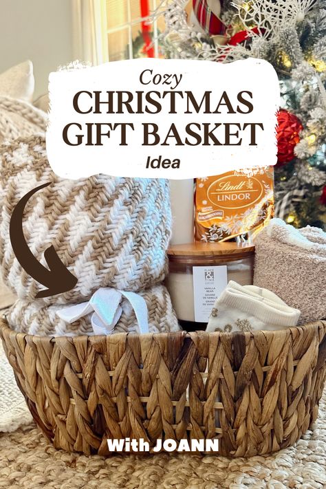 Cozy Christmas Basket from JOANN: blanket, candles, chocolates, tumblers—curated by She Gave It A Go! 🎁✨ #handmadewithjoann #HolidayJoy #CozyHome Family Baskets For Christmas, Christmas Wicker Basket Ideas, Cozy Themed Gift Basket, Gift Basket Ideas Under $25, Candle Gift Baskets Ideas, Throw Blanket Gift Basket Ideas, Blanket Gift Basket Ideas, Cozy Christmas Basket, Cozy Gift Basket Ideas For Women