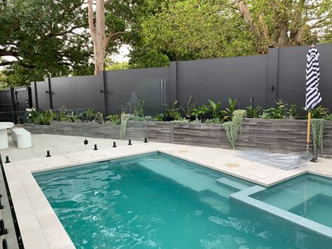 Designed by Penelope Ellen Interiors and exteriors in Melbourne ViC Pool And Retaining Wall, Pool Area Retaining Wall, Retaining Wall Next To Pool, Tile Fence Wall, Pool Next To Retaining Wall, Pools With Retaining Walls Design, Concrete Sleeper Retaining Wall, Courtyard Tiles, Concrete Sleeper Retaining Walls