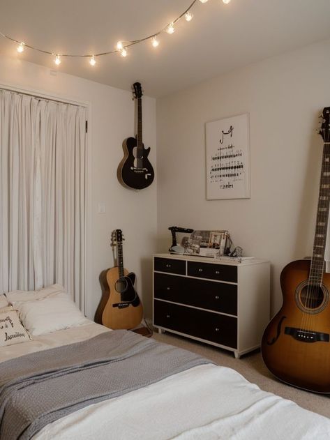 Create a music-themed bedroom aesthetic using a vinyl record as a unique wall art piece and a guitar as a decorative element. Hang string lights to create a whimsical vibe, and incorporate musical notes or lyrics as decals on the walls. Bedroom Music Studio Aesthetic, Music Lover Bedroom, Bedroom Music Studio, Couples Room, Music Themed Bedroom, Music Bedroom, Student Bedroom, Music Corner, Neutral Bedrooms